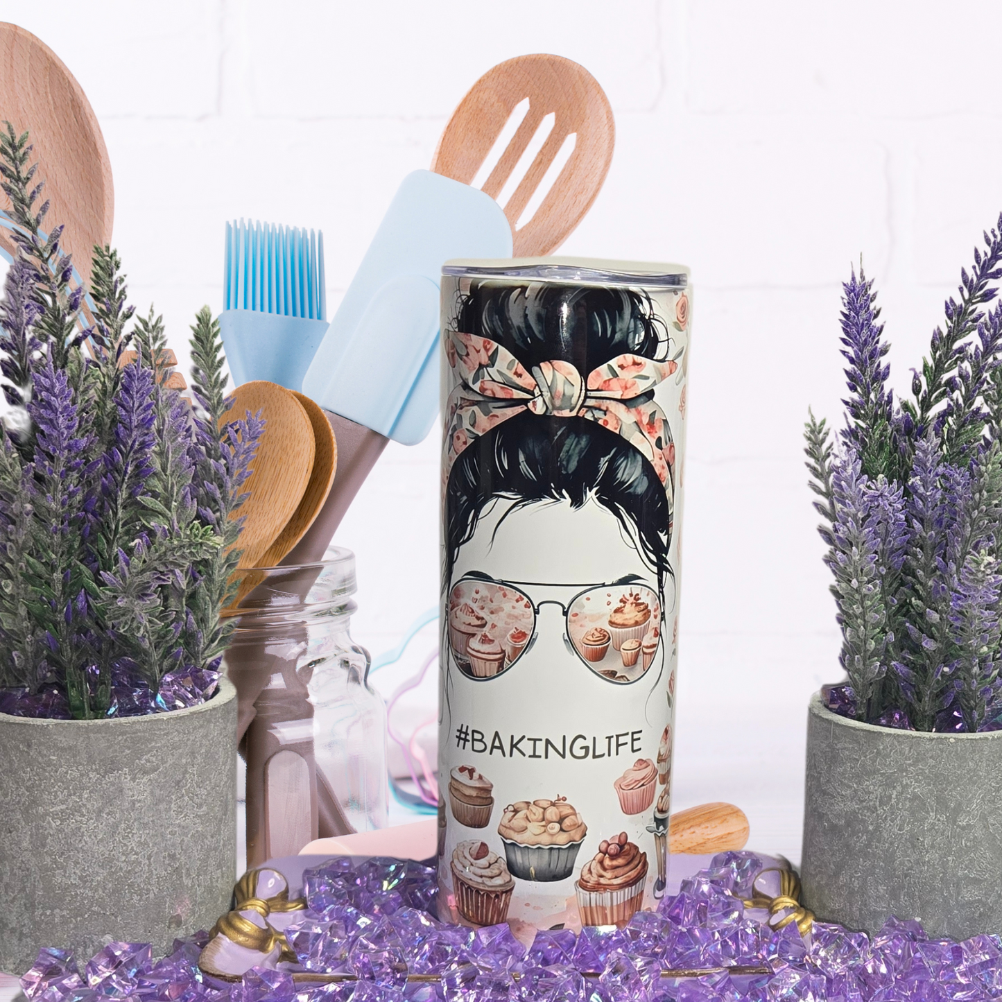 BakingLife 20 oz Stainless Steel Tumbler with messy bun, cupcake sunglasses, and spill-proof lid among kitchen decor.