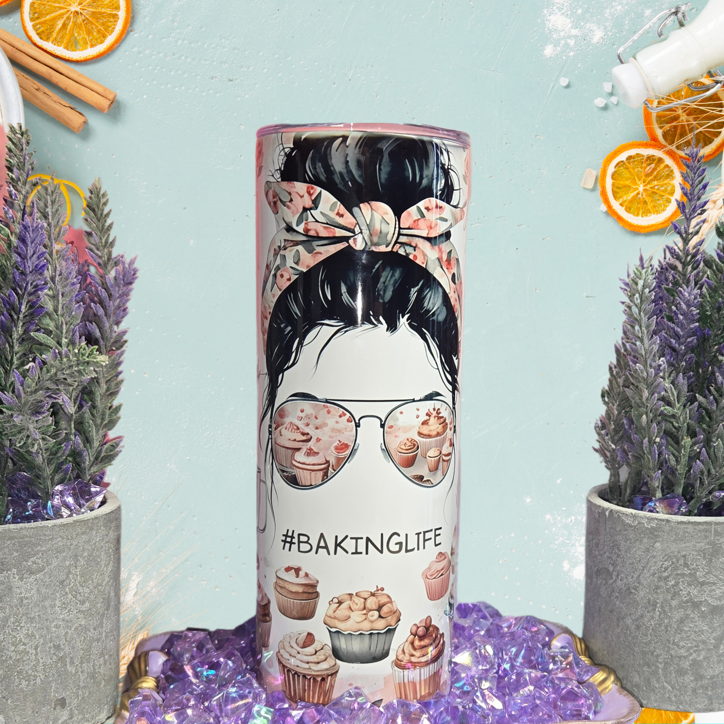 BakingLife 20 oz Stainless Steel Tumbler with messy bun and cupcake sunglasses design on a blue background.