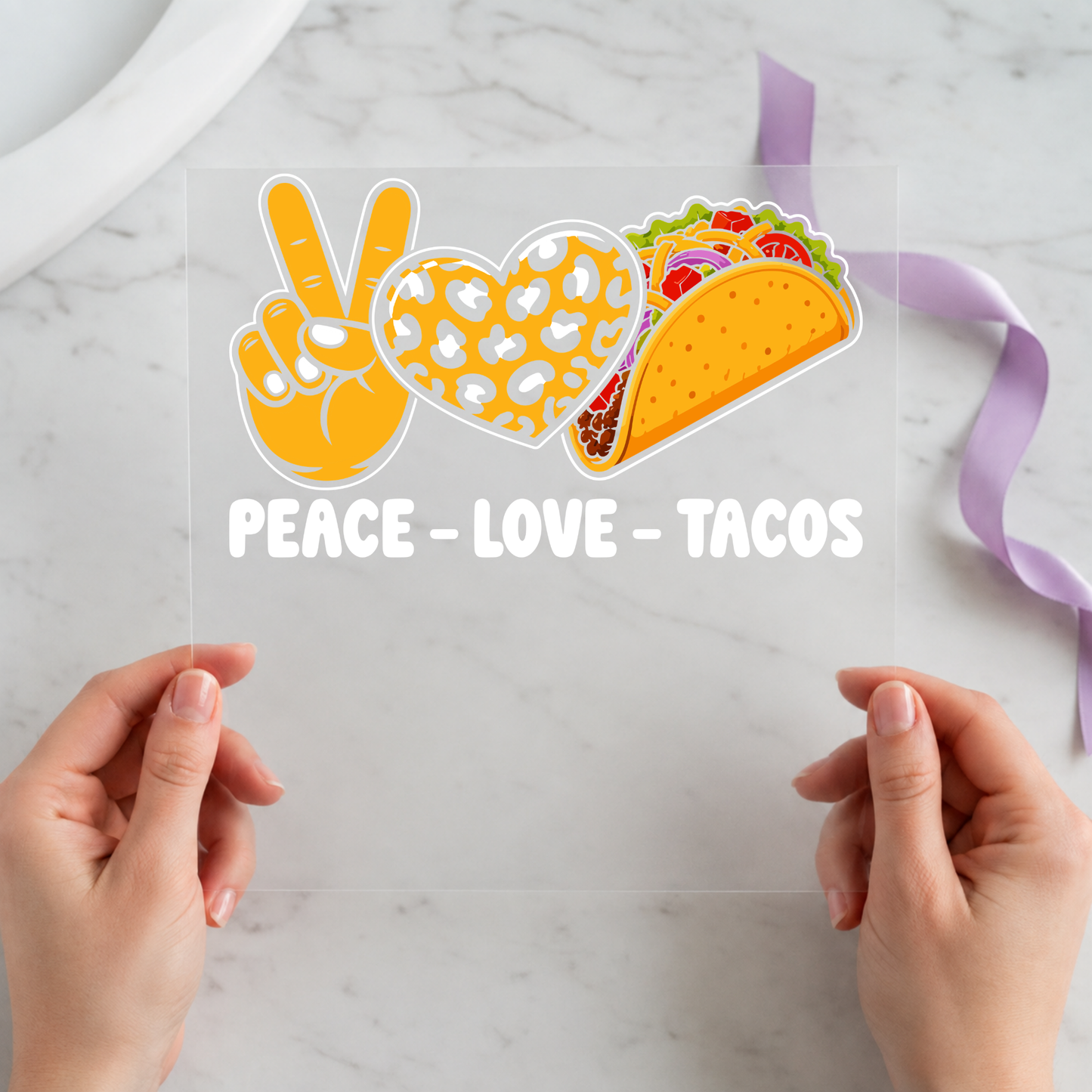 Peace Love Tacos featuring peace hand, patterned heart and taco icons above white lettering on a 12x12 ready-to-press DTF heat transfer
