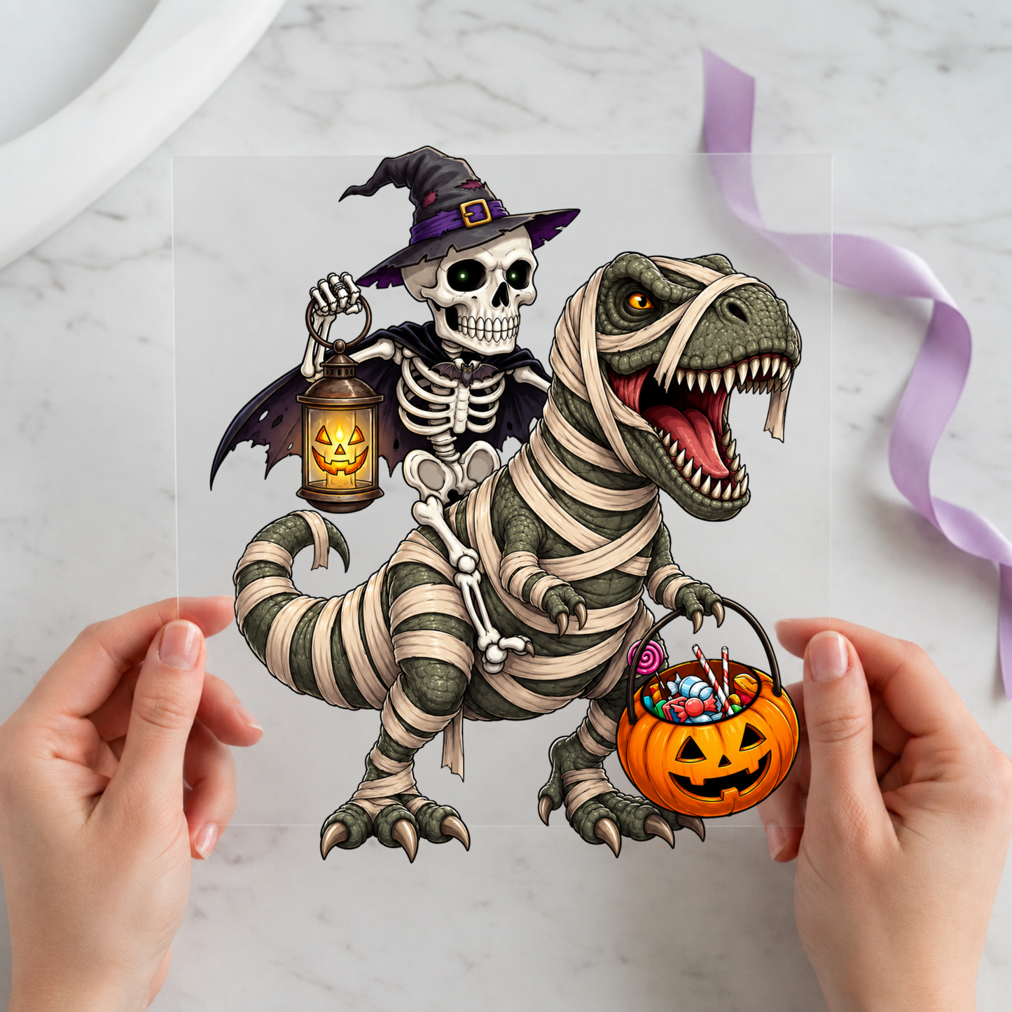 Skeleton Witch Riding a Dinosaur featuring witch skeleton riding a mummy-wrapped dinosaur with pumpkin bucket on a 12x12 ready-to-press DTF heat transfer