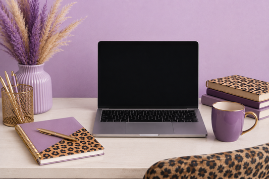 Cozy purple and cheetah print home office workspace with laptop, lavender decor, gold accents, and feminine entrepreneur desk setup for a small business burnout blog post.