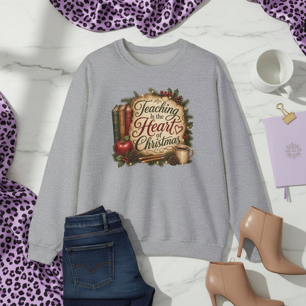 Teaching Is the Heart of Christmas Custom Graphic Sweatshirt showing the phrase Teaching Is the Heart of Christmas with festive classroom-inspired artwork