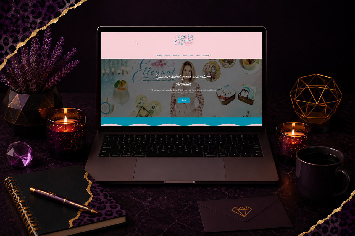 Laptop displaying a baking website on a dark desk with purple candles, notebook, pen, coffee mug, and geometric decor pieces