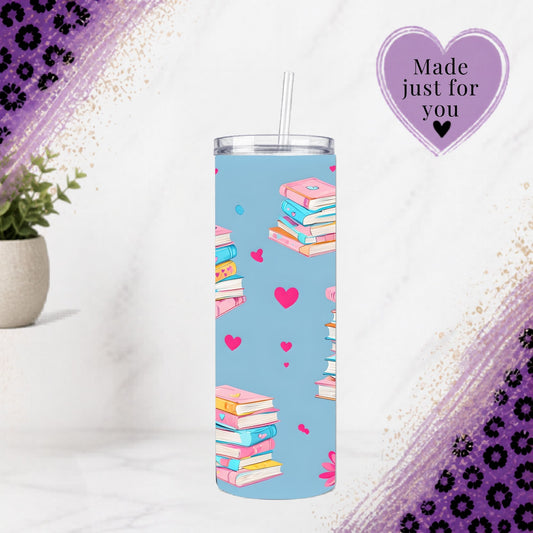 Pastel Book Lover 20oz Tumbler | Pink Floral Reader Cup with colorful book stacks and hearts on light blue background.