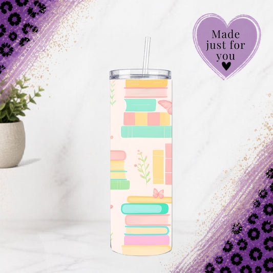 Pastel Bookworm 20oz Tumbler | Floral Library Reader Cup with colorful book stack design and clear straw on marble surface