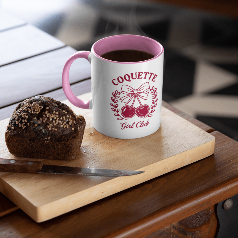 Aesthetic Cherry Coquette Coffee Mug with cherry bow design and pink interior on wooden board with bread.