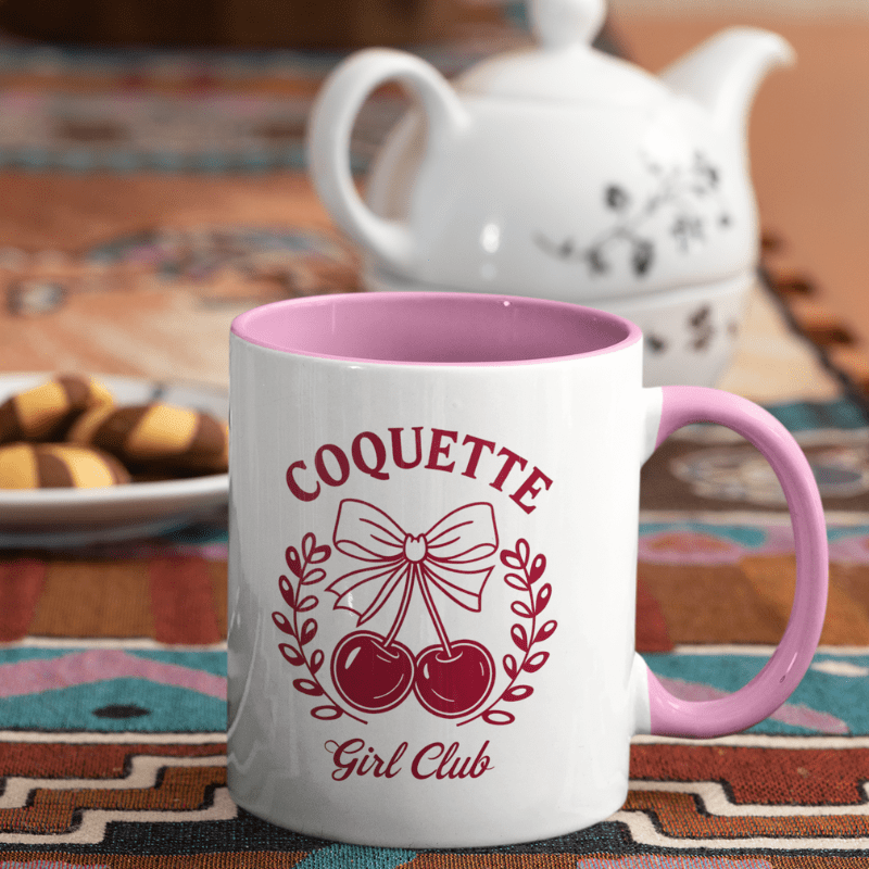 Aesthetic Cherry Coquette Coffee Mug with cherry bow design and Coquette Girl Club text, pink handle and interior.