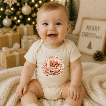 Baby Girl First Christmas Bodysuit Infant Bodysuit Outfit showing an adorable gingerbread girl surrounded by pink ornaments, gifts, festive accents, and "My 1st Christmas" artwork