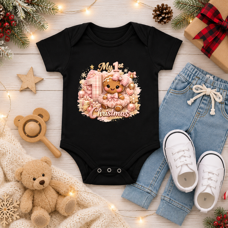 Baby Girl First Christmas Bodysuit Infant Bodysuit Outfit showing an adorable gingerbread girl surrounded by pink ornaments, gifts, festive accents, and "My 1st Christmas" artwork