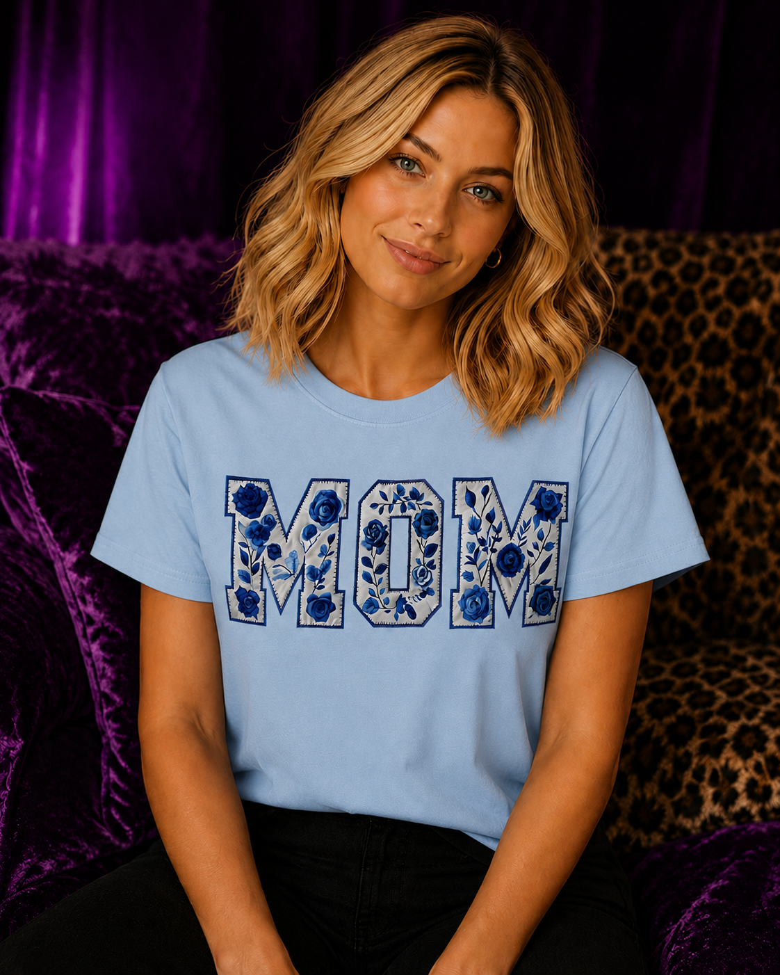 Blonde woman wearing a light blue Gildan Blue Floral Mom T-Shirt featuring blue chinoiserie floral MOM lettering