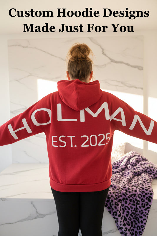 Customer Rochelle wearing a personalized Holman Est. 2025 hoodie inside the Marie Gems office showcasing custom apparel and handmade hoodie printing