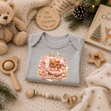 Baby Girl First Christmas Bodysuit Infant Bodysuit Outfit showing an adorable gingerbread girl surrounded by pink ornaments, gifts, festive accents, and "My 1st Christmas" artwork