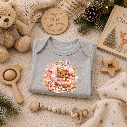 Baby Girl First Christmas Bodysuit Infant Bodysuit Outfit showing an adorable gingerbread girl surrounded by pink ornaments, gifts, festive accents, and "My 1st Christmas" artwork