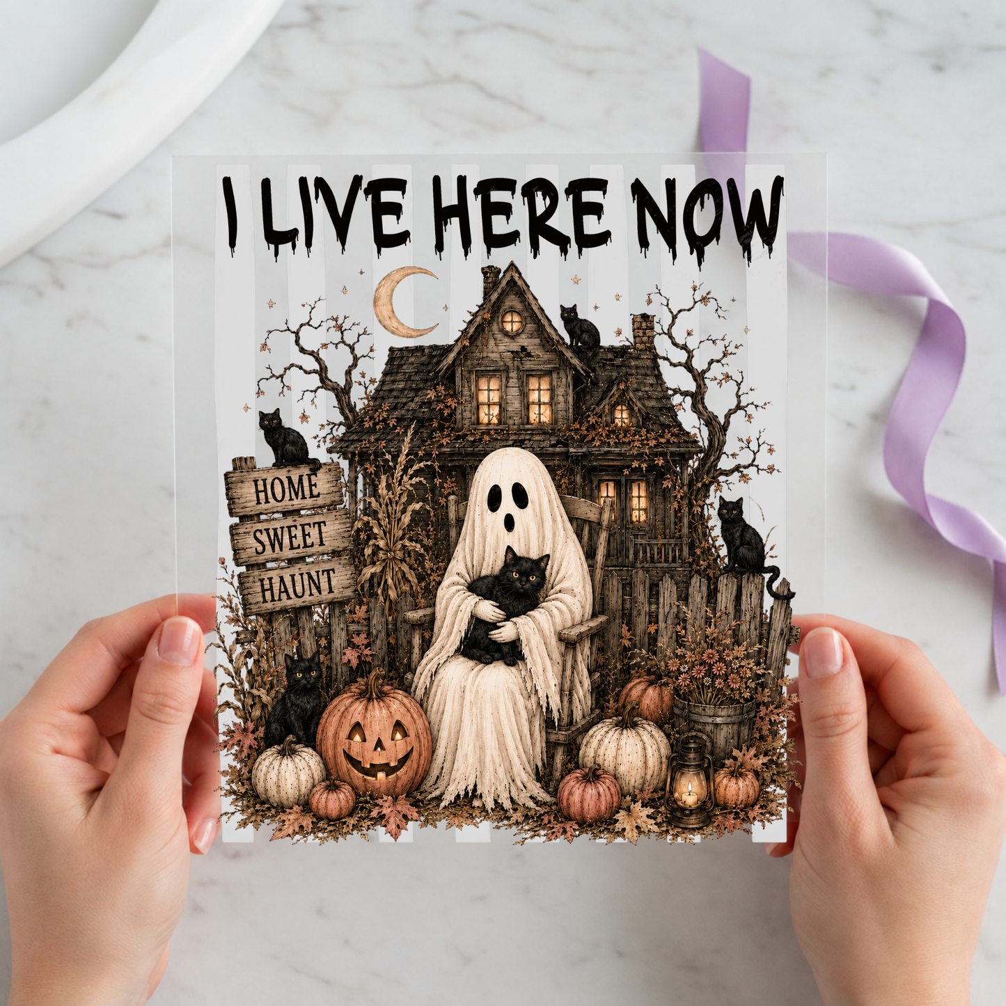 I Live Here Now Haunted House Ghost featuring white ghost seated before a detailed haunted house and pumpkins on a 12x12 ready-to-press DTF heat transfer