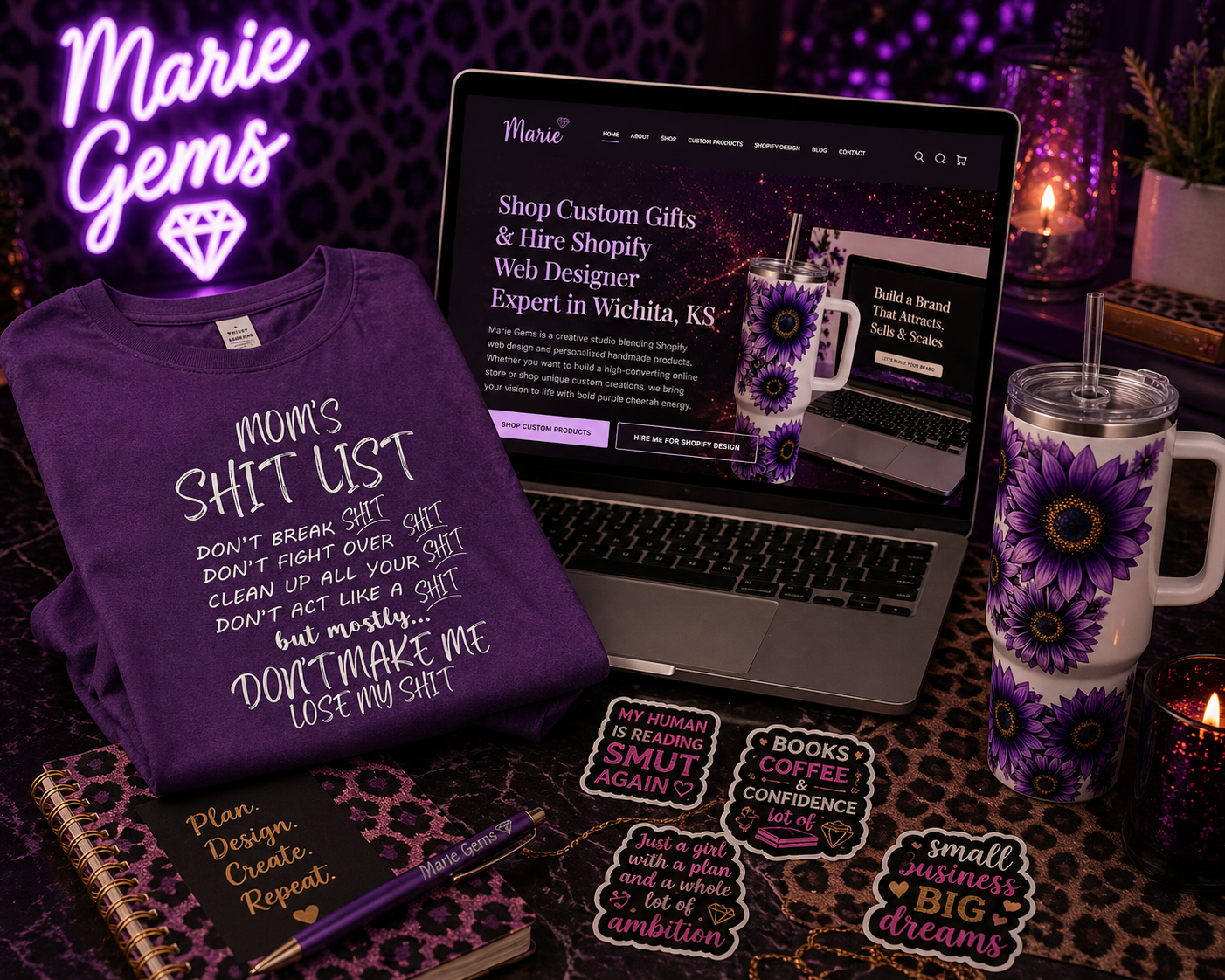 Marie Gems flatlay featuring custom graphic apparel, sublimation tumblers, waterproof stickers, and Shopify web design branding with signature purple and cheetah print aesthetic