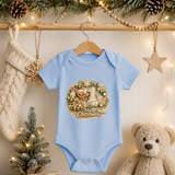 My First Christmas Baby Bodysuit Infant Bodysuit Outfit showing an adorable teddy bear in a Santa hat riding in a decorated Christmas sleigh, surrounded by candy canes, gingerbread