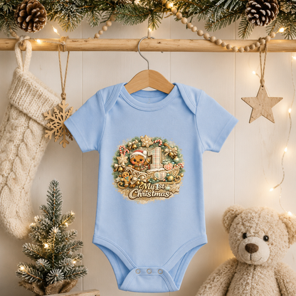 My First Christmas Baby Bodysuit Infant Bodysuit Outfit showing an adorable teddy bear in a Santa hat riding in a decorated Christmas sleigh, surrounded by candy canes, gingerbread