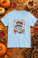 Cute Fall Raccoon t-shirt in light blue with leopard bow raccoon graphic, styled flat lay with pumpkins, maple leaves, cinnamon sticks and a cheetah print scarf