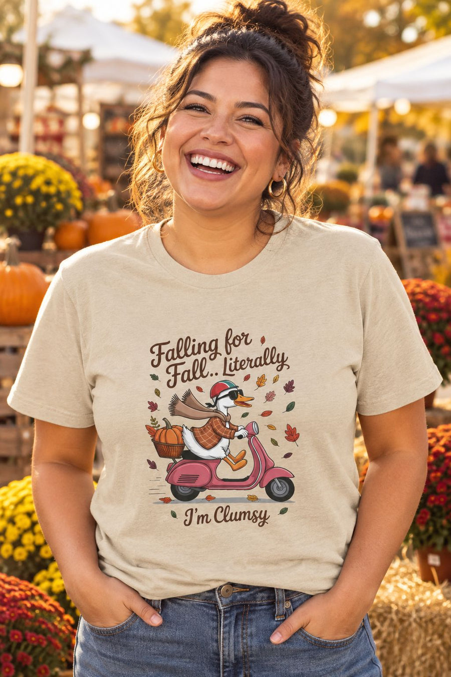 Person wearing the Falling for Fall Literally I'm Clumsy t-shirt in sand with goose on a scooter graphic in a fall setting