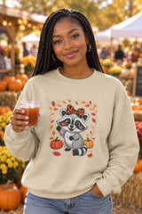 Person wearing the Cute Fall Raccoon crewneck sweatshirt in sand with leopard bow raccoon graphic in a fall setting