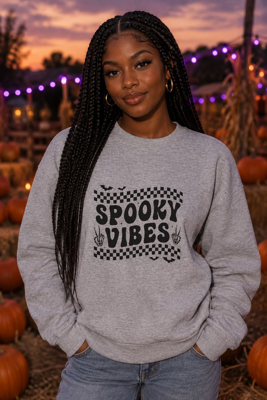 Person wearing the Spooky Vibes Retro Checkerboard crewneck sweatshirt in sport grey with checkerboard Spooky Vibes graphic in a fall setting