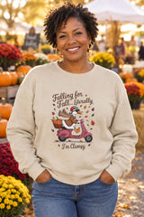 Person wearing the Falling for Fall Literally I'm Clumsy crewneck sweatshirt in sand with goose on a scooter graphic in a fall setting