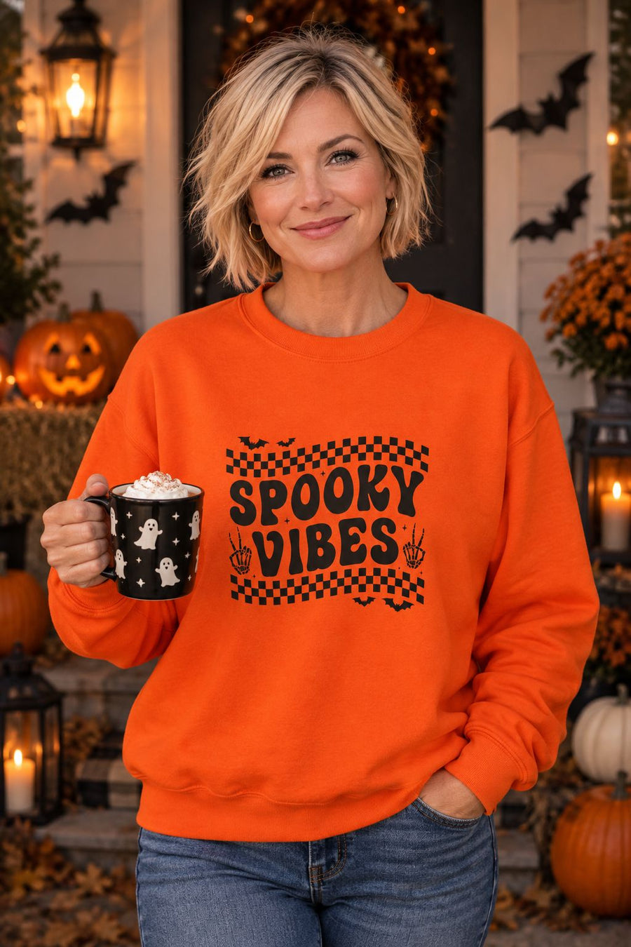 Person wearing the Spooky Vibes Retro Checkerboard crewneck sweatshirt in orange with checkerboard Spooky Vibes graphic in a fall setting