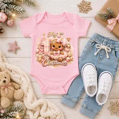 Baby Girl First Christmas Bodysuit Infant Bodysuit Outfit showing an adorable gingerbread girl surrounded by pink ornaments, gifts, festive accents, and "My 1st Christmas" artwork