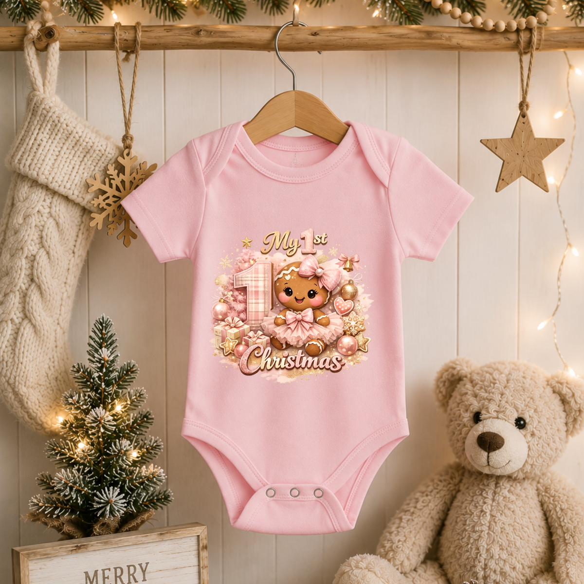 Baby Girl First Christmas Bodysuit Infant Bodysuit Outfit showing an adorable gingerbread girl surrounded by pink ornaments, gifts, festive accents, and "My 1st Christmas" artwork
