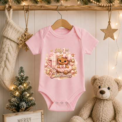 Baby Girl First Christmas Bodysuit Infant Bodysuit Outfit showing an adorable gingerbread girl surrounded by pink ornaments, gifts, festive accents, and "My 1st Christmas" artwork