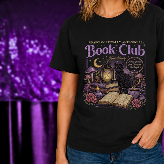 Unapologetically Anti Social Book Club Shirt for Introvert Readers with mystical book, cat, and lantern design on black fabric