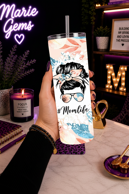 Momlife Made-to-Order 20 oz Stainless Steel Tumbler showing a sweet messy bun floral design in soft peach tones, this tumbler blends cozy style with everyday function, product
