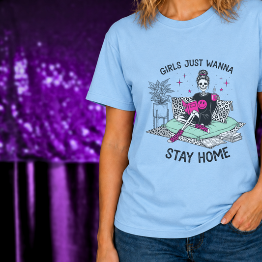 Girls Just Wanna Stay Home T-Shirt | Cozy Introvert Tee | Comfort First Shirt with skeleton reading and coffee on blue fabric