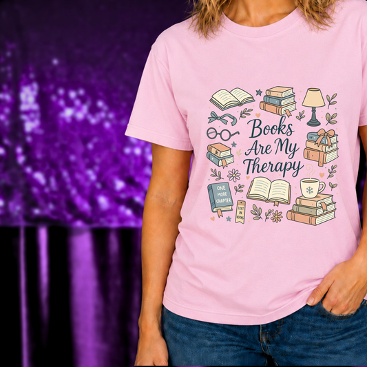 Books Are My Therapy T-Shirt | Cozy Reader Tee | Book Stack Graphic Shirt with stacks of books and cozy reading items on pink tee