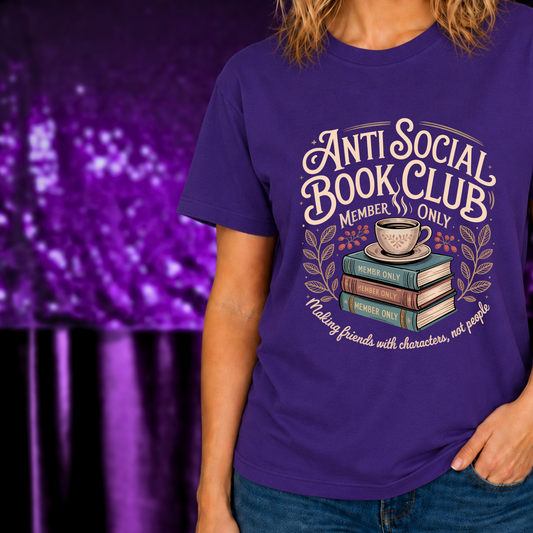 Cozy Coffee & Books Anti Social Book Club T-Shirt for Readers with book stack and coffee cup graphic on purple fabric